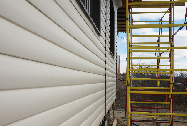 Vinyl Siding Installation on scaffold